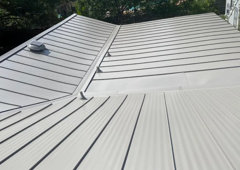 Solar attic fan installed on a metal roof for Roof Ventilation in Mansfield